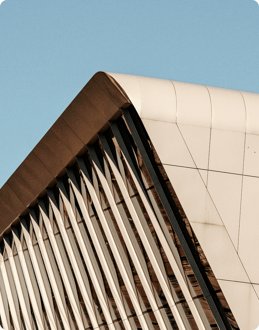 Modern architectural building with angled white panels and vertical slats.